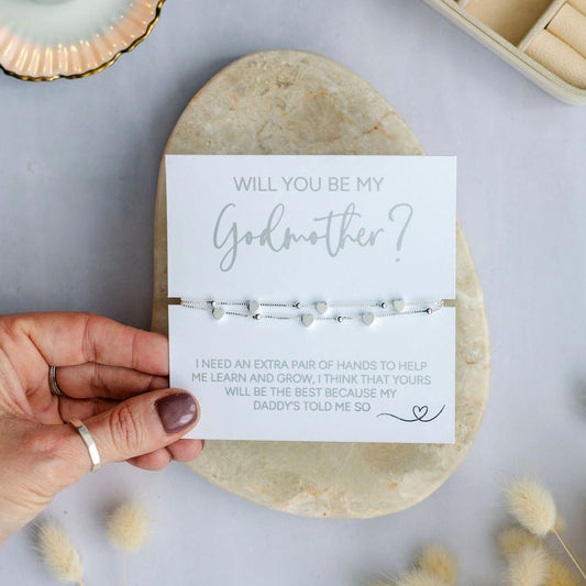 Elegant silver ‘’Will You Be My Godmother’ bracelet from the child’s Daddies, perfect Godmother proposal gift, heart charm keepsake, meaningful christening or baptism jewellery, thoughtful LGBTQ+ baby announcement present.