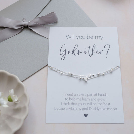 Elegant silver Godmother proposal bracelet with star and moon charms on card saying “Will you be my Godmother?”, perfect christening and baptism gift